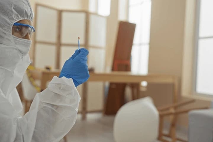 a person collecting a substance on a swab