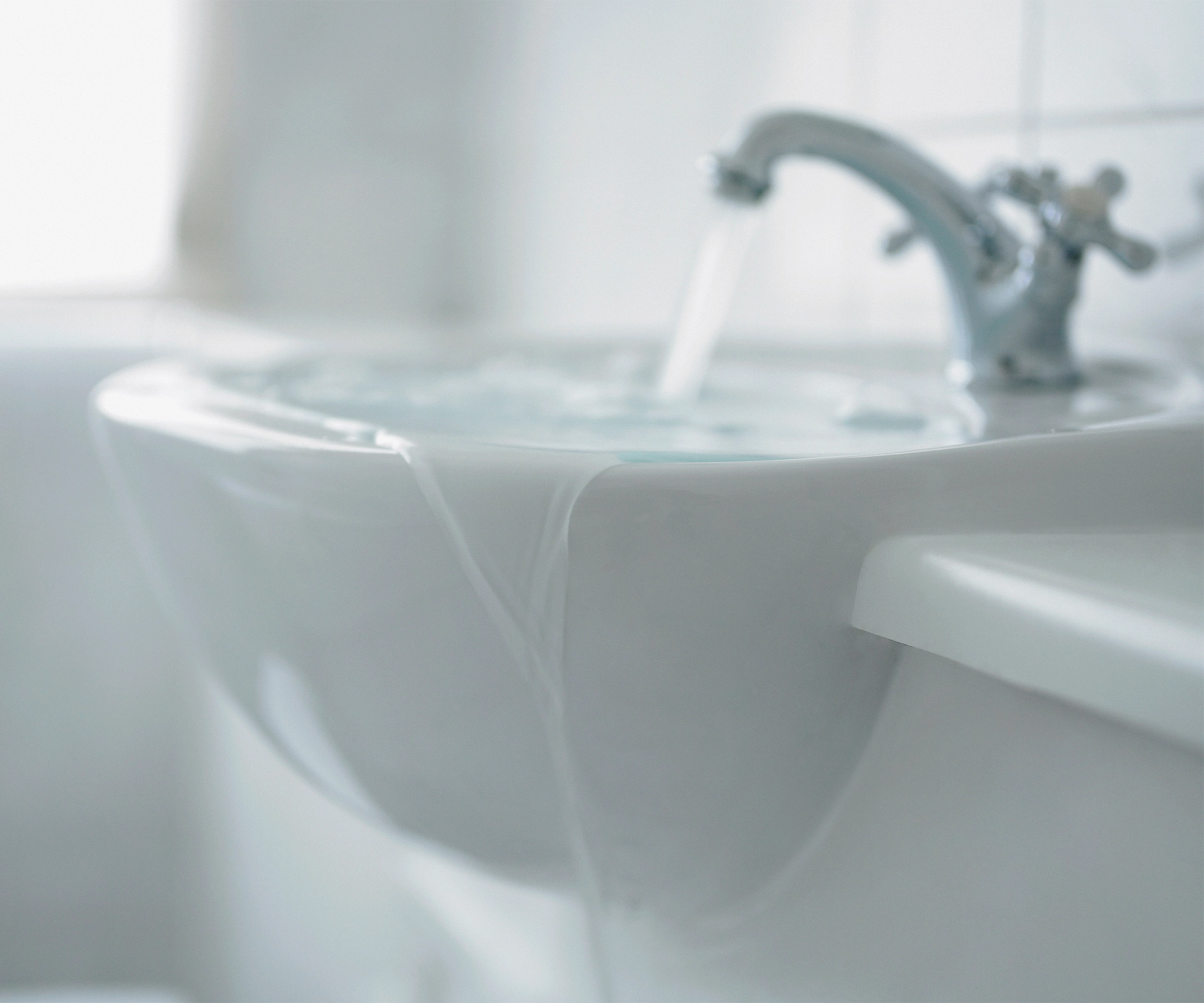 Sink overflowing with running water