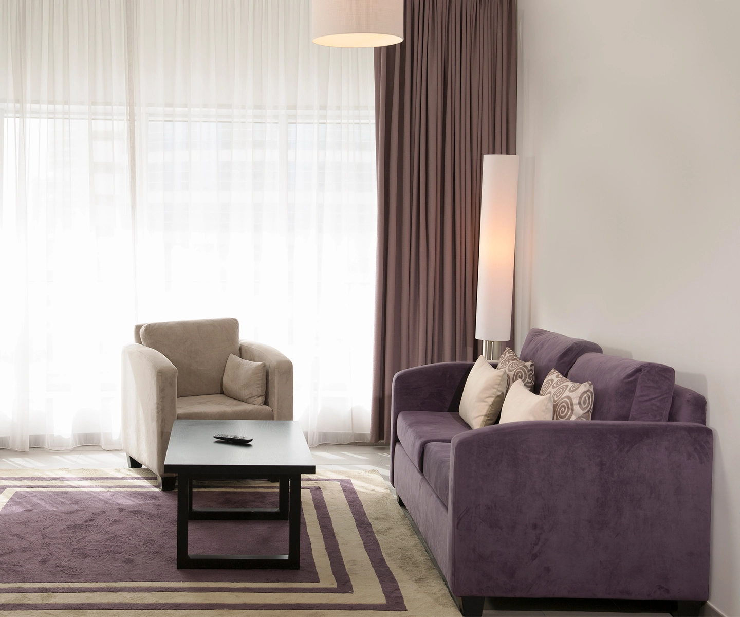 Living room with floor-to-ceiling curtained window