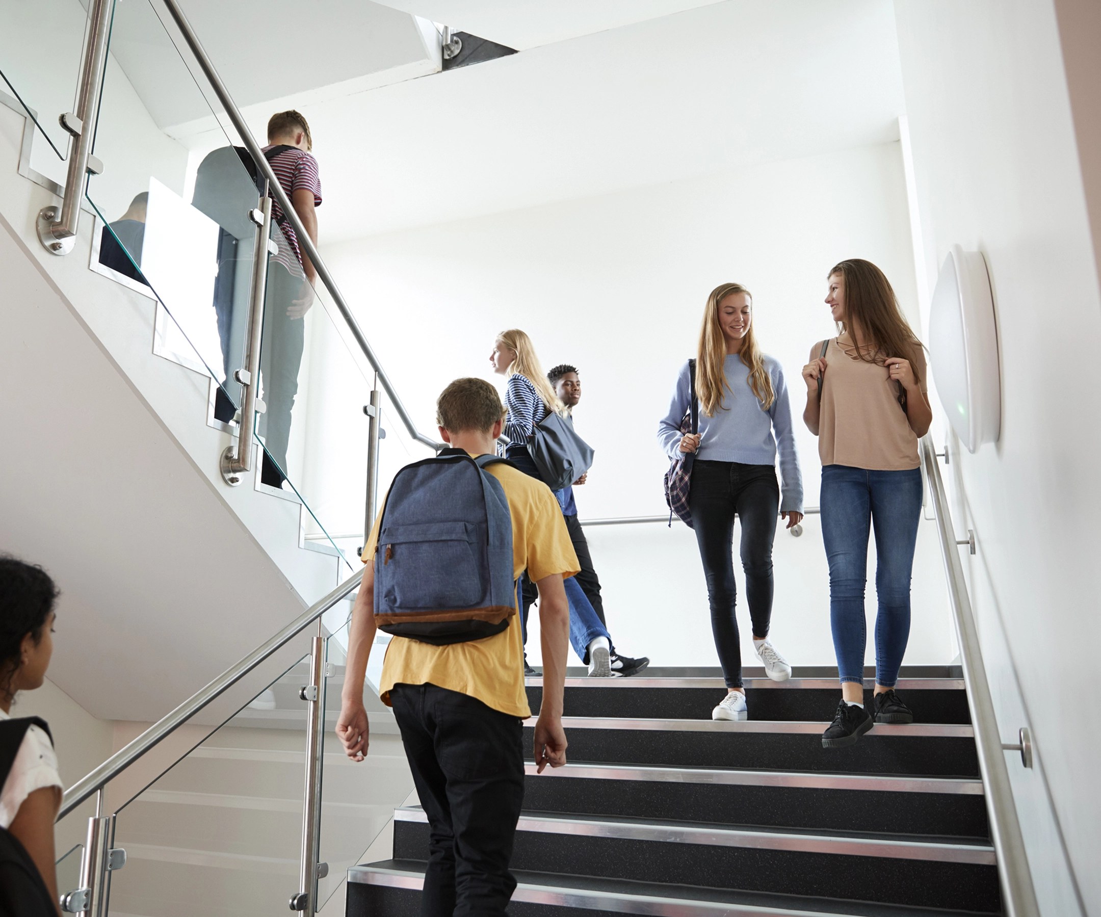 Students walking on stairwell in educational facility