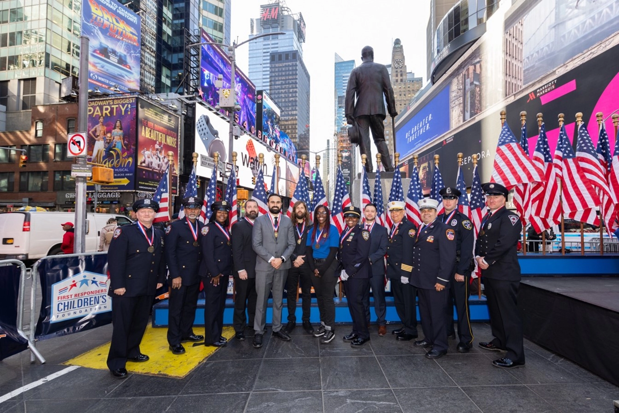 A group of people in uniform standing in front of a statue